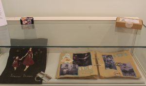 Display case with fabric items inside.